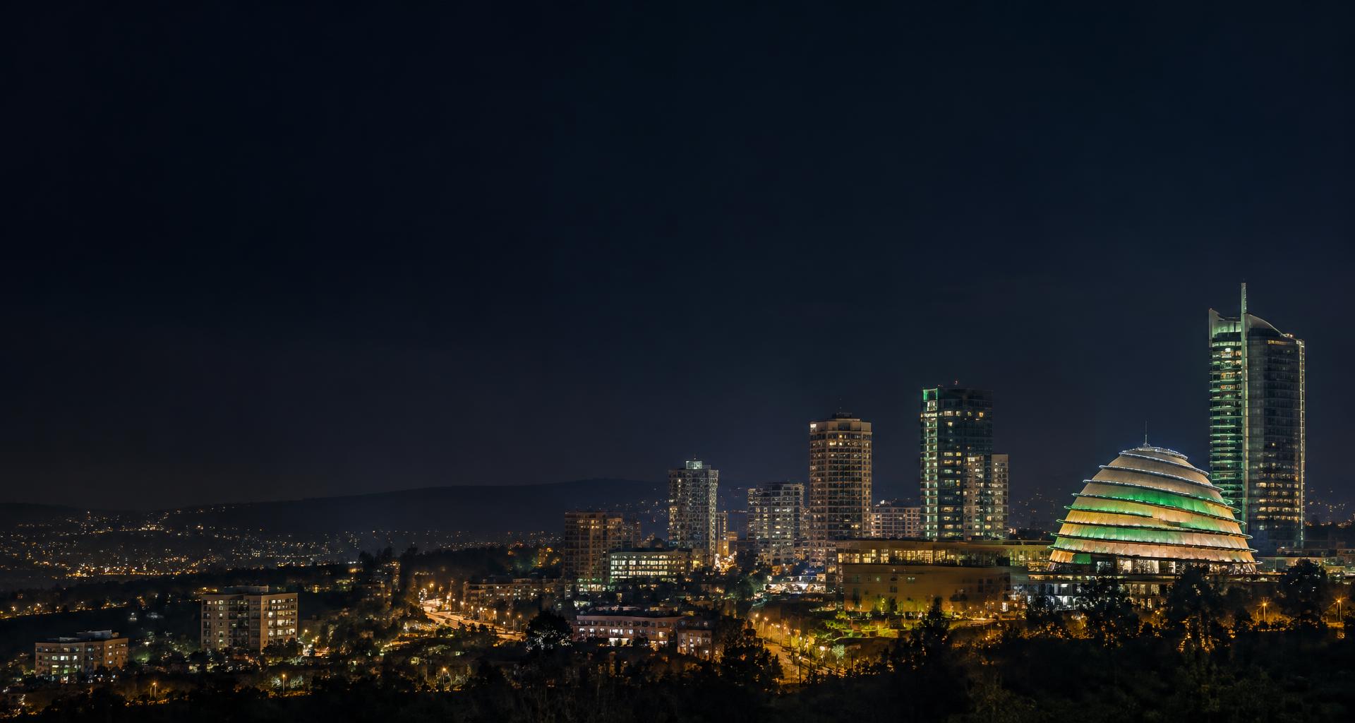 Kigali skyline at night, an editorial illustration of Rwanda’s connected economy